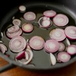 pink and white round candies on black round plate